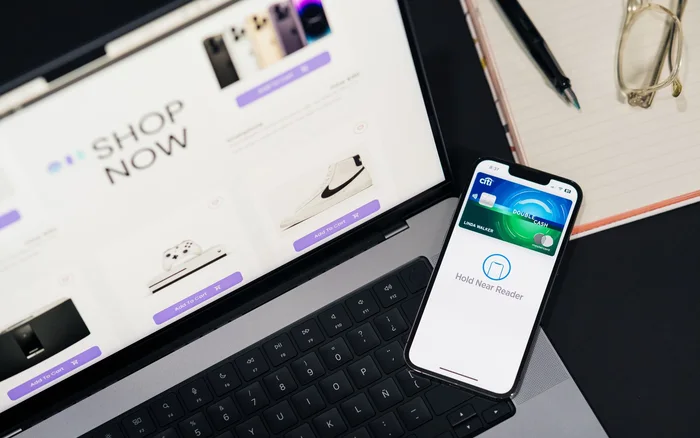 Laptop displaying an online store beside a mobile payment screen