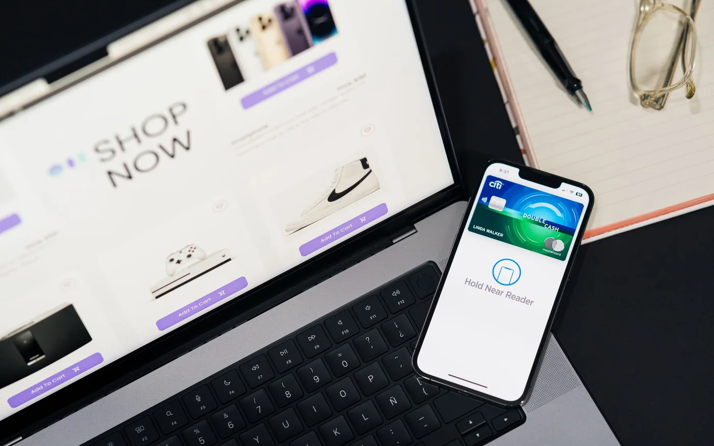 Laptop displaying an online store beside a mobile payment screen