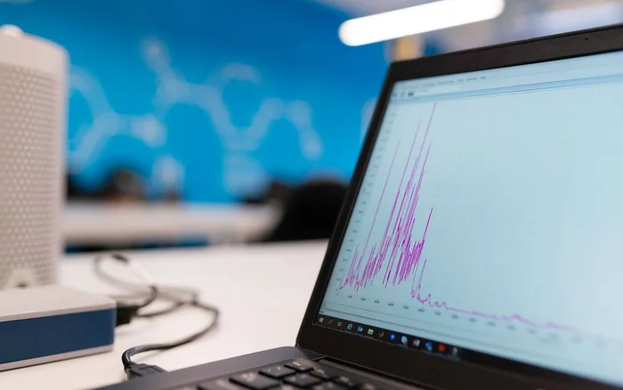 Laptop showing a graph in a technical workspace